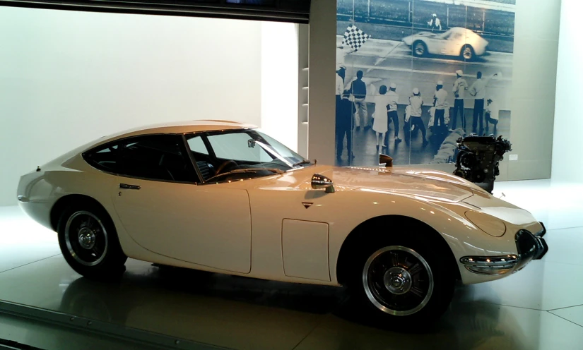 a tan sports car parked on a display