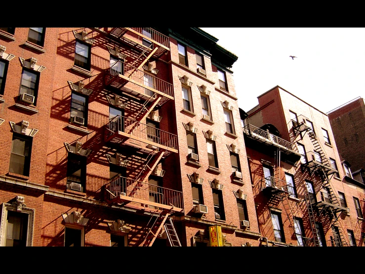 a group of fire escapes near brick buildings