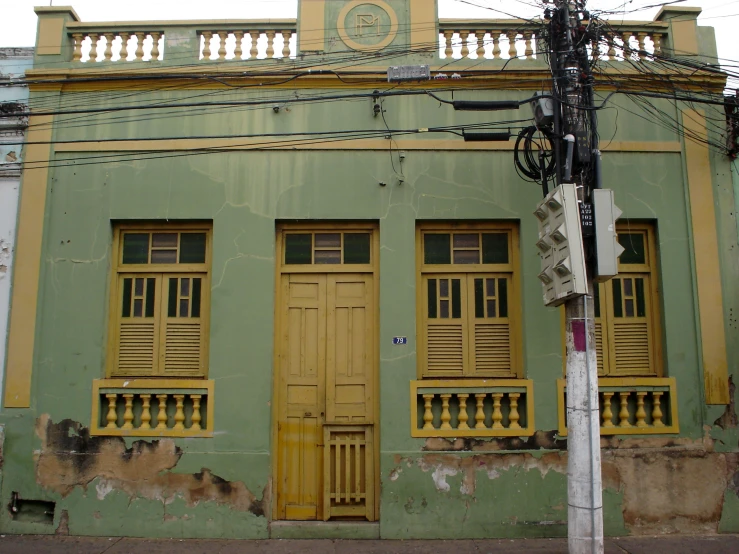 a corner with two yellow and green doors and windows