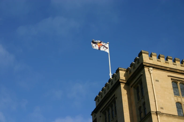 an older building has a flag that reads it