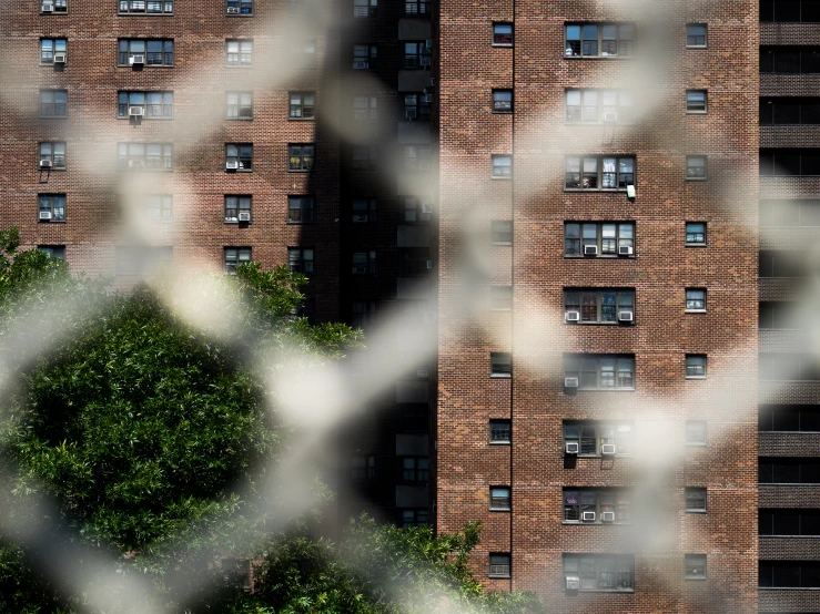 the top view of a building is seen through an iron fence