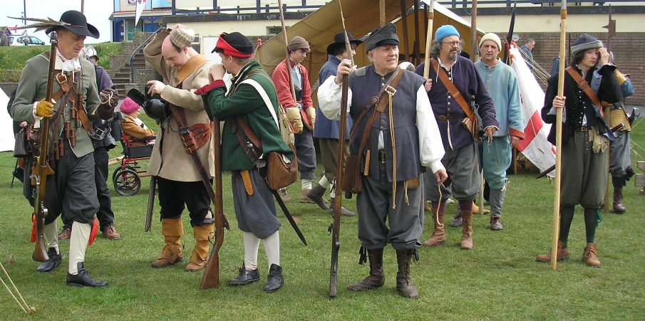 a group of people standing on top of a field next to each other