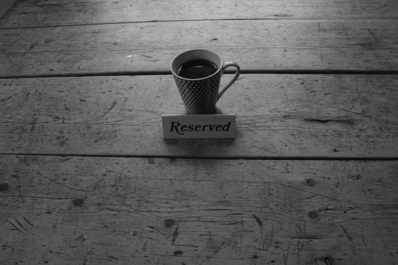 a cup sits on the table that says reserved