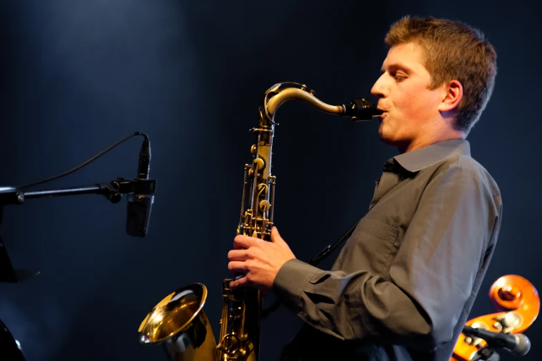 a man with a saxophone playing on stage