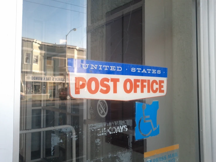 the sign says post office in an american town