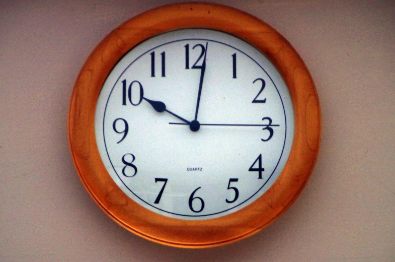 a small wall clock with one hour hand on the side