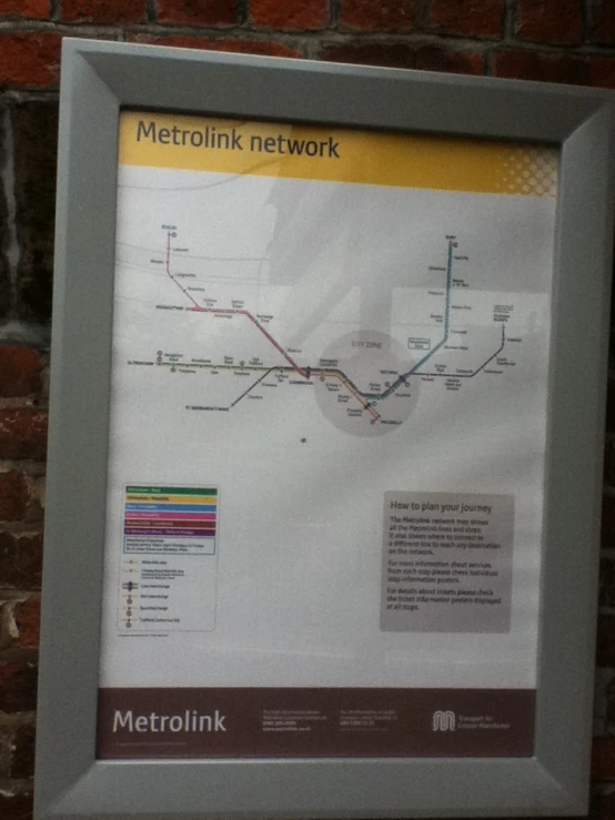 a white subway map in front of a brick wall