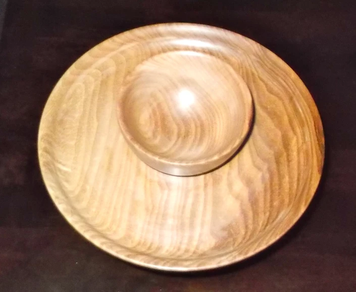 a wooden bowl sitting on top of a table