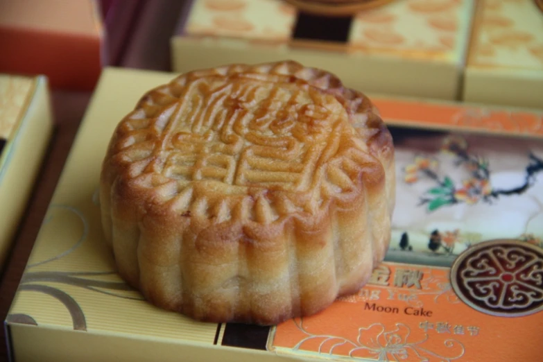 a moon cake sitting on top of some colorful items