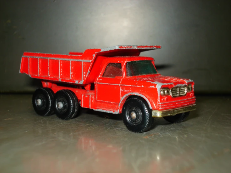 a red toy truck is sitting on the table