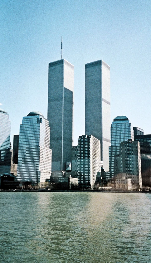 a group of tall buildings with cars parked in front of it