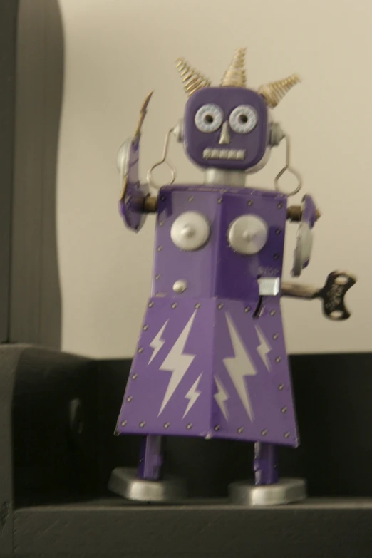 this toy robot is purple and has horns on it