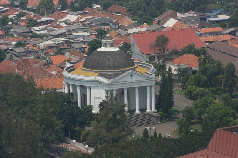 large dome in middle of city with orange roofs