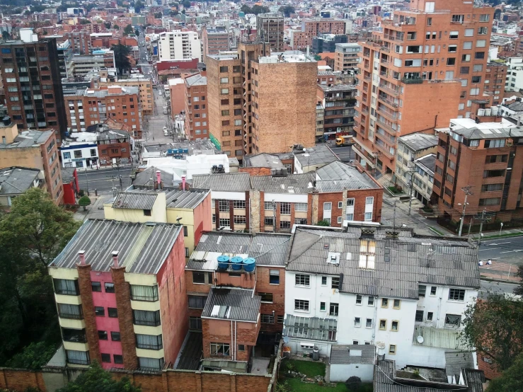 a small city from a high viewpoint, with the buildings painted red and blue