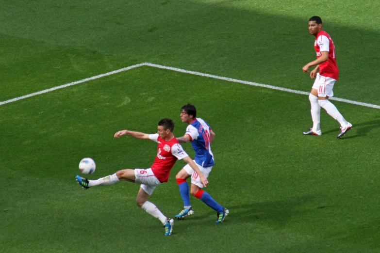 a group of soccer players kicking around a soccer ball