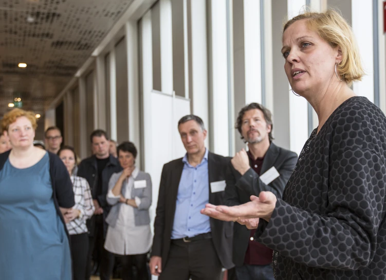 a woman standing in front of a group of people