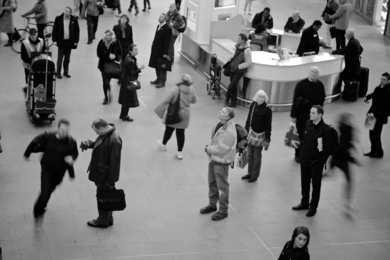 many people standing together inside of an indoor mall