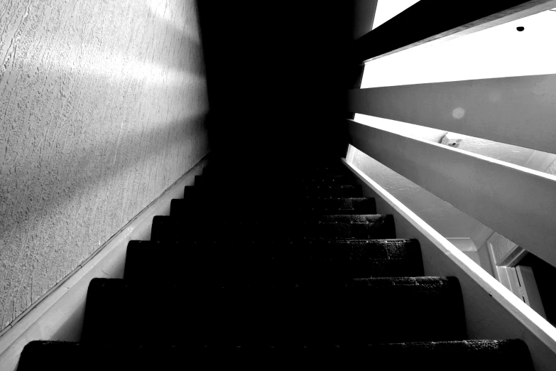 a black and white po of someone walking down the stairs