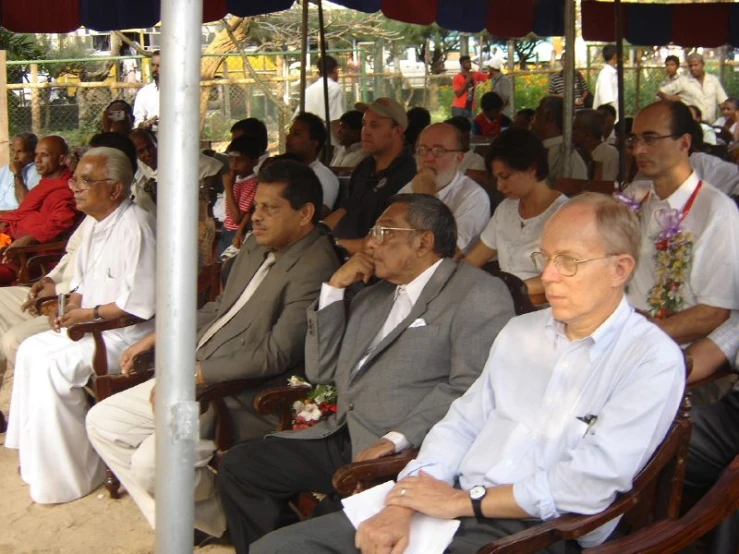 a large group of people sitting next to each other