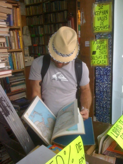 a man looking at books on display inside a book shop