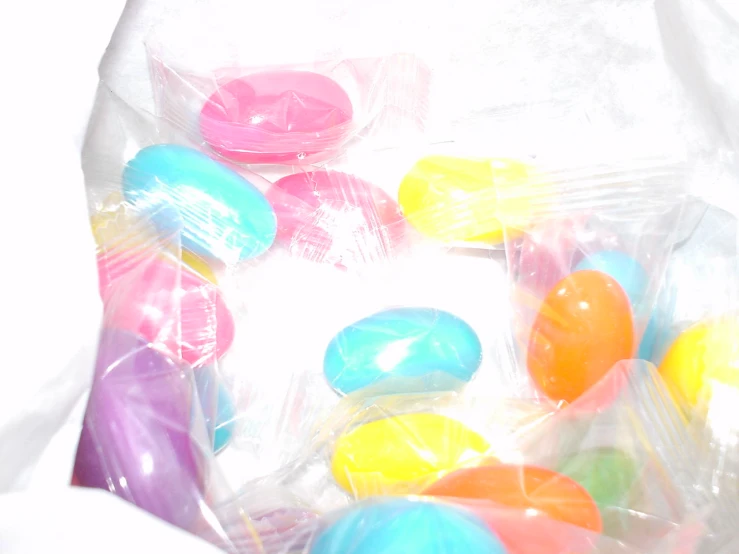 many plastic candy candies are displayed in a bag