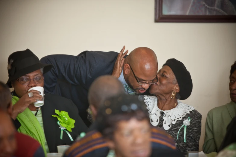 a man and woman kissing on the foreheads at a celetion