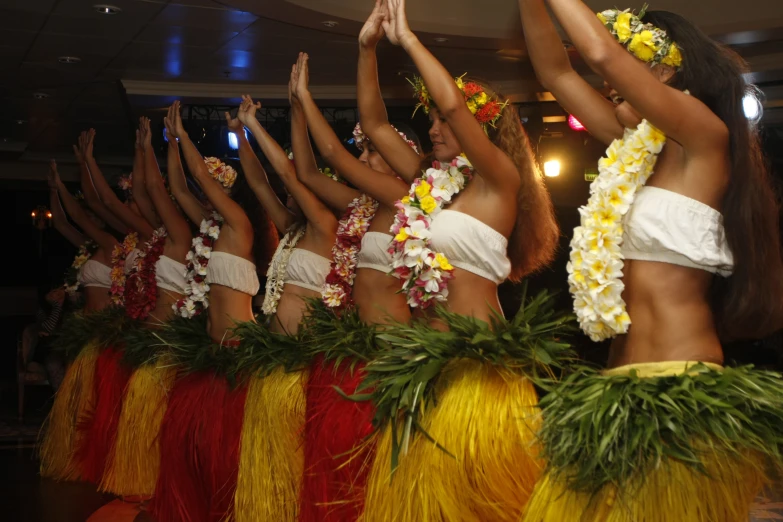 women in flowers and hula skirts at a event