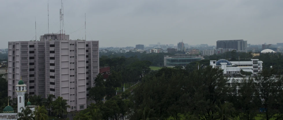 a cloudy day over a city with tall buildings