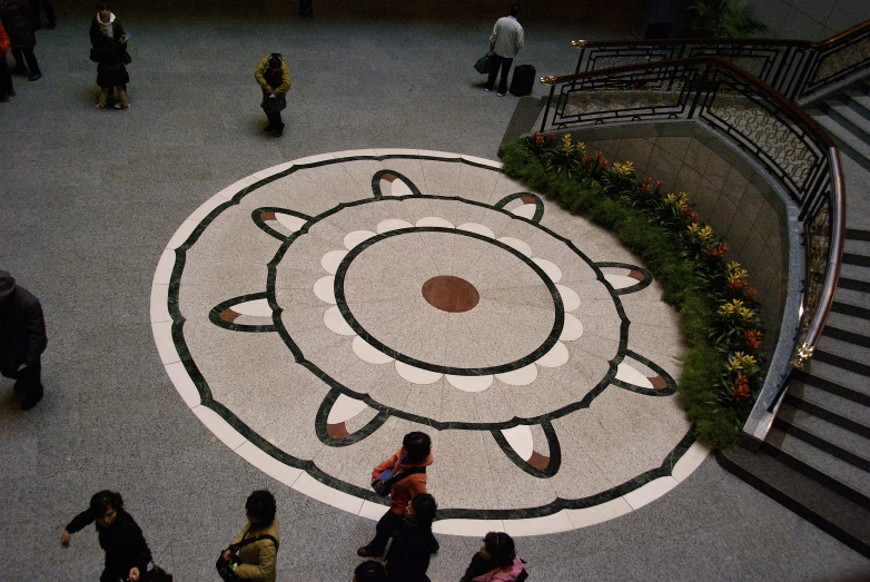 a group of people standing on top of a sidewalk