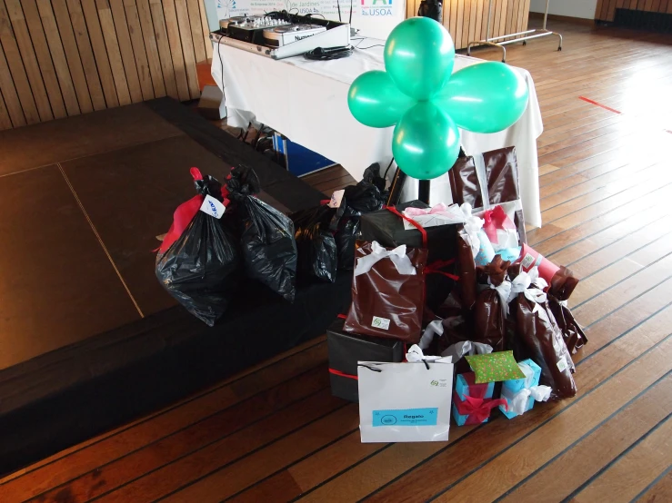 there is a table set up with bags and a balloon