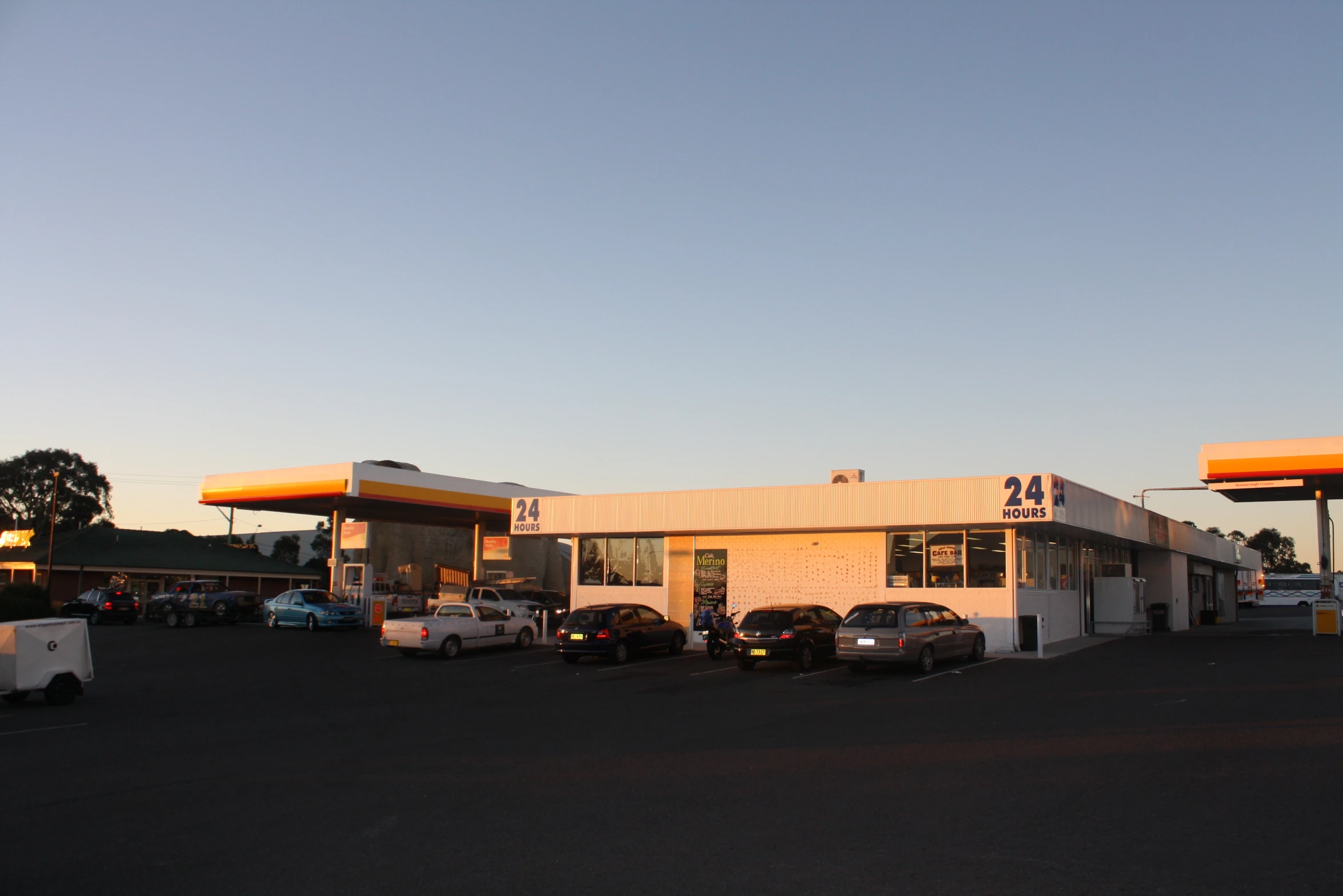 a gas station with cars parked in front