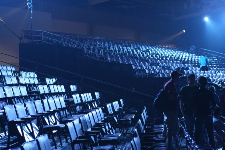 the rows of seats on the back side of a soccer field are dark