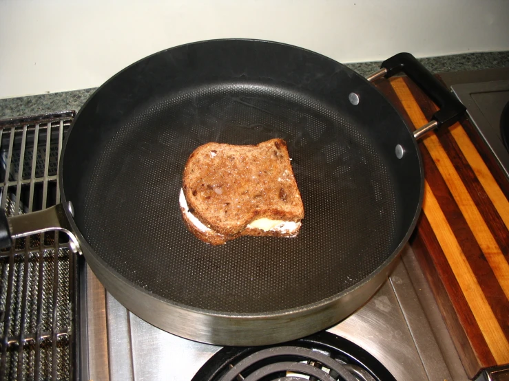 a grilled sandwich on a plate in a frying pan