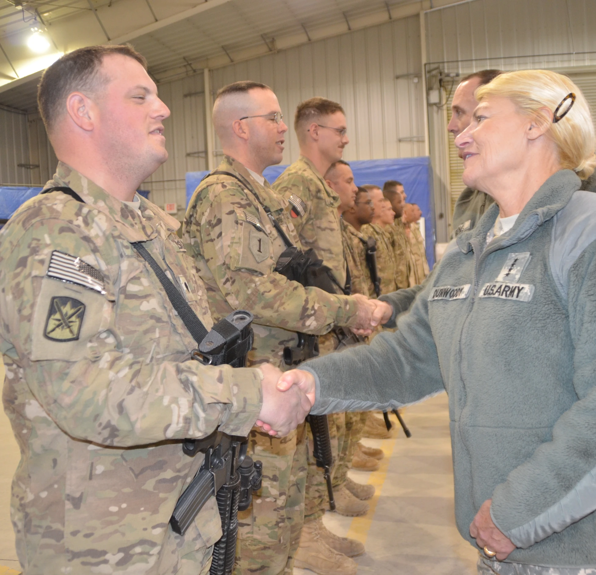 a man and woman shaking hands during a meeting