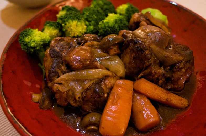 a bowl full of stew and vegetables on a table