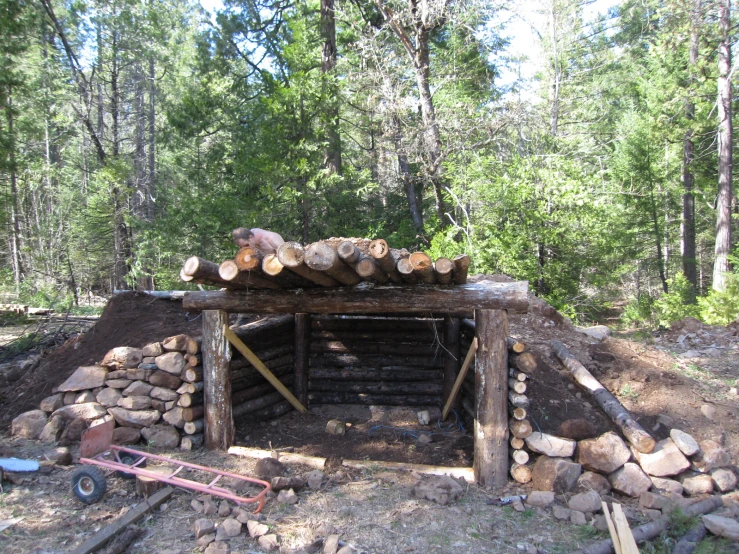 a fire place with piles of wood stacked up on the top of it