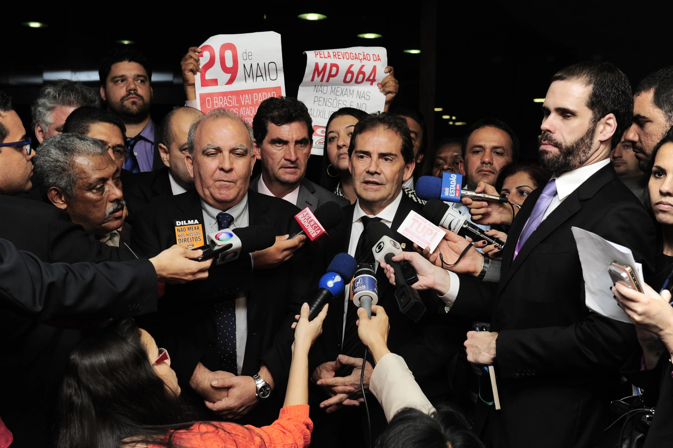 a man in suit surrounded by a crowd