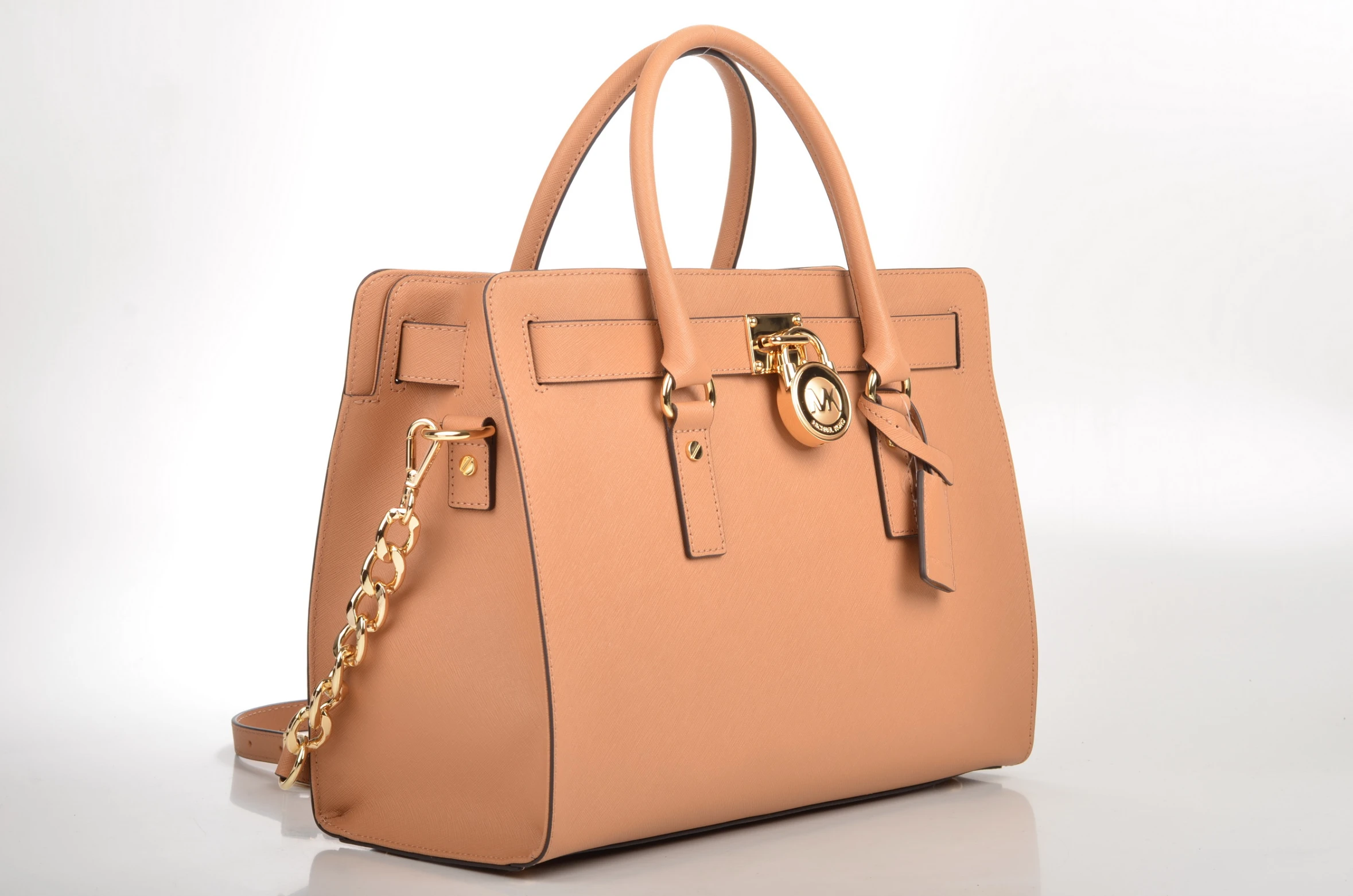 a light brown handbag with golden hardwares