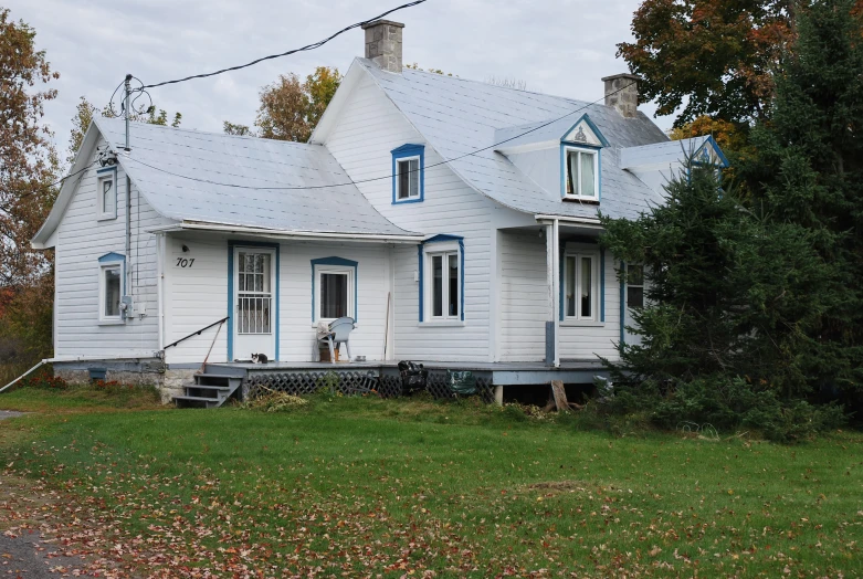 an old home with two story has blue shutters