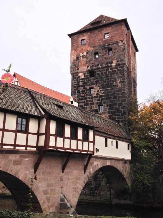 an old brick building with two stories on top and two bridges below