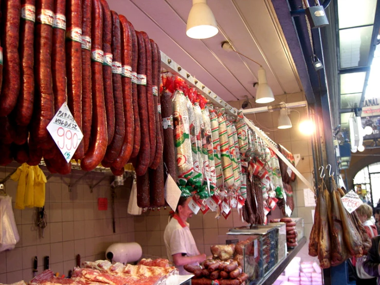 several people are buying sausages at the store