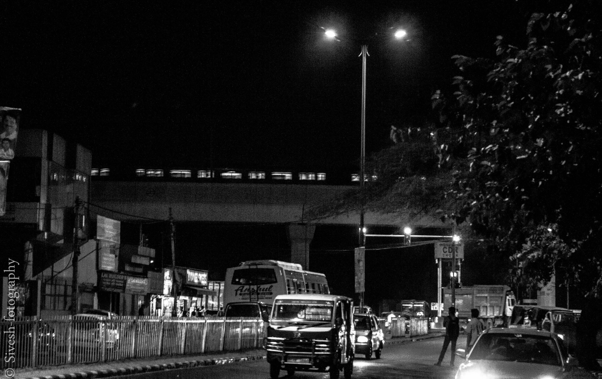 a large truck traveling down a city street at night