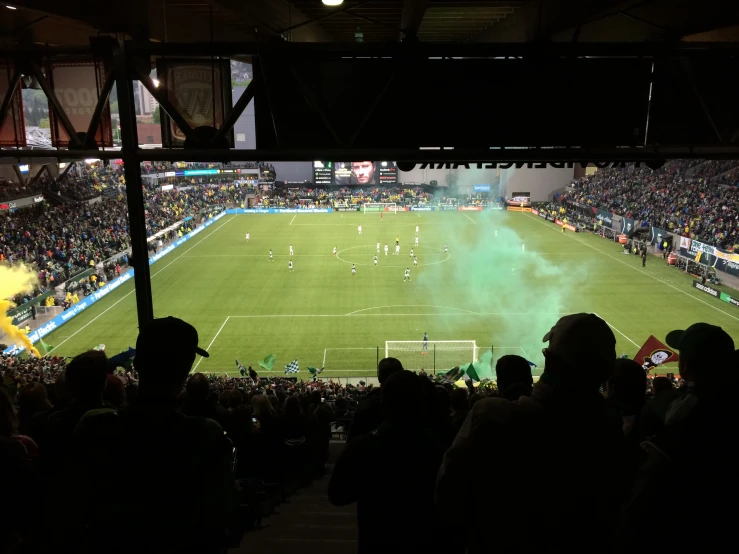 an audience watches as the teams play in a soccer match