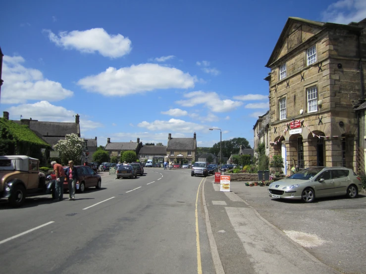 a view of a street that has some people walking on it