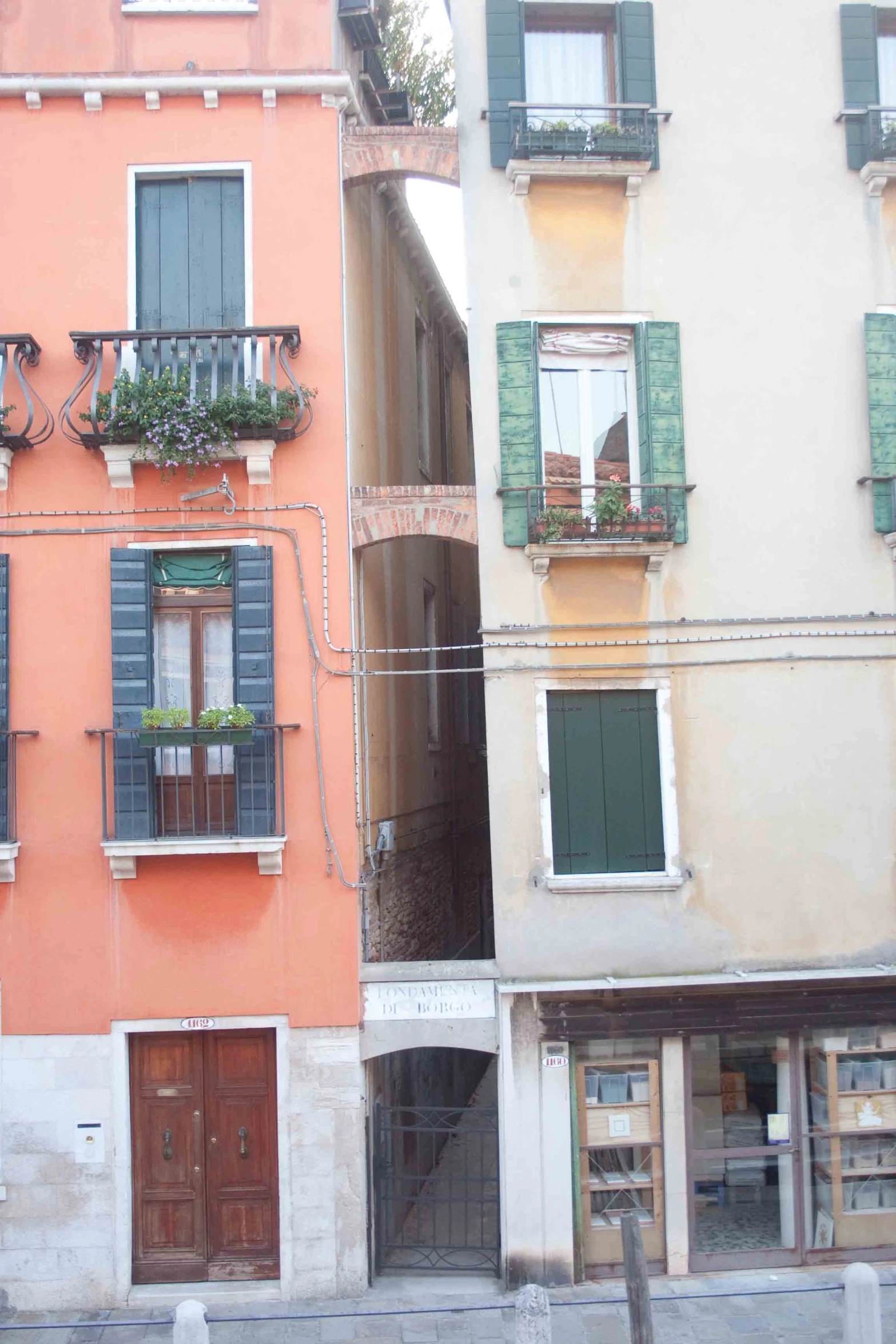 buildings with wooden doors and windows lined up on the street