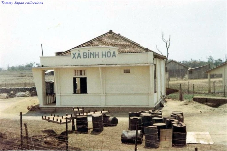 an old building with a tin roof and the word ka binh hoa is on the side of it