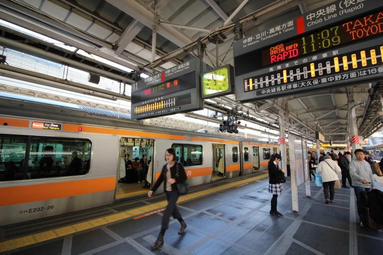 a group of people getting on a train