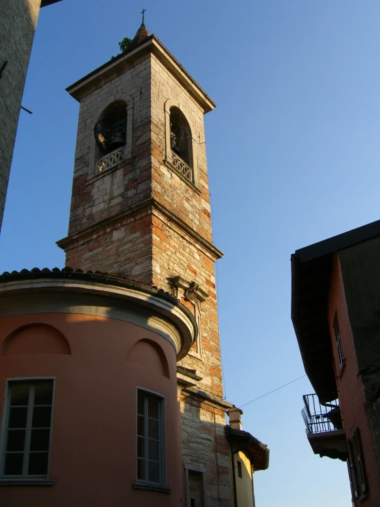 the tall brick clock tower is above a building