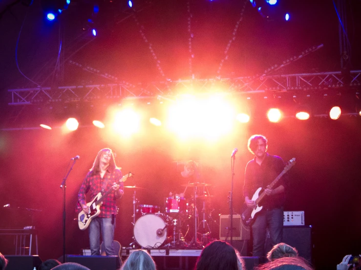 band members on stage performing on an evening show