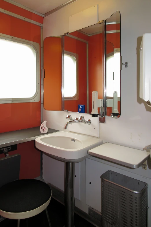 a bright bathroom with double sinks and two mirrors